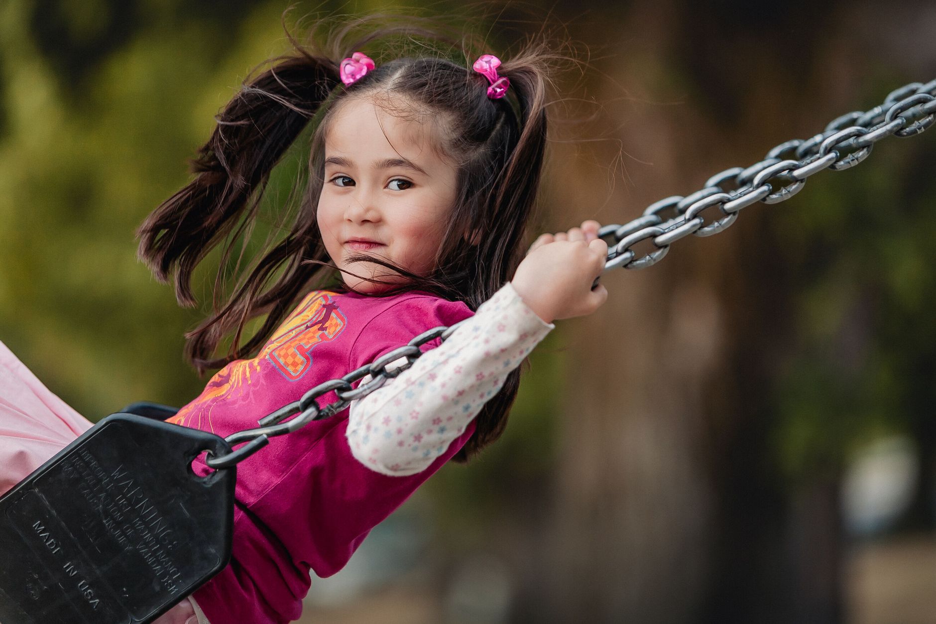 happy child enjoying a swing in canadian park
